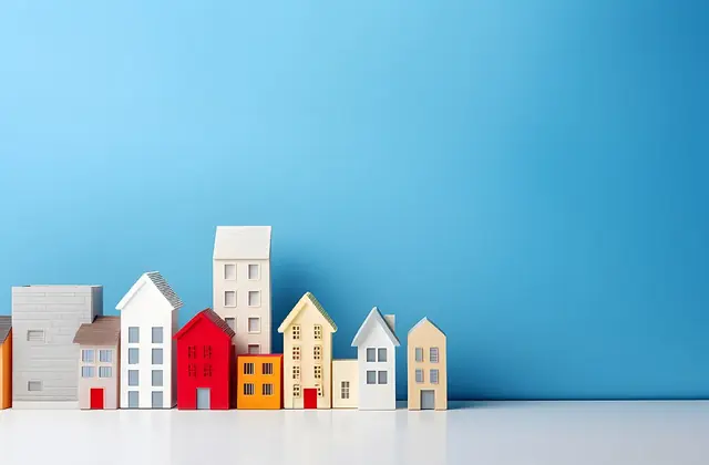 Row of small colorful model houses against a blue background